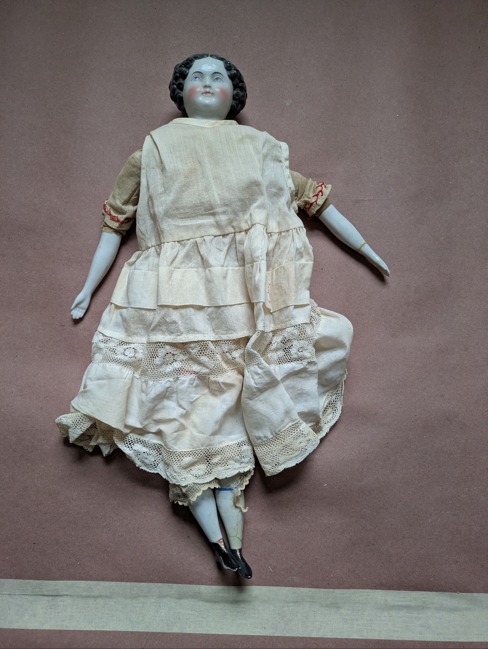Antique China Doll.  Porcelain, Flat Head, Soft Body Center.  Original Clothing.